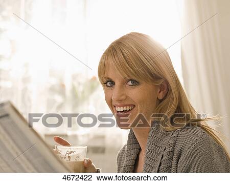 Young woman with newspaper in bed View Large Photo Image Stock Image - Young woman with newspaper in bed . Fotosearch