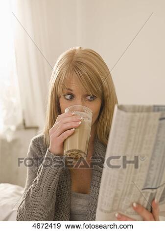 Young woman with newspaper in bed View Large Photo Image Stock Photo - Young woman with newspaper in bed . Fotosearch