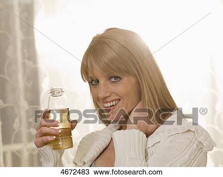Stock Image - Young woman with plastic bottle . Fotosearch