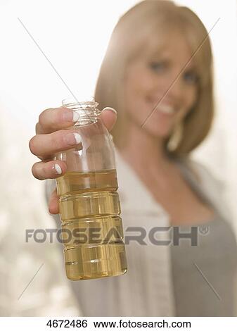 Young woman with plastic bottle View Large Photo Image Stock Photograph - Young woman with plastic bottle . Fotosearch