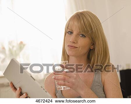 Picture - Young woman with Tablet PC in bed . Fotosearch