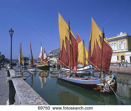 Boats anchored in canal, Italian Riviera, Cesenatico Port, Italy View Large Photo Image Stock Image - Boats anchored in canal, Italian Riviera, Cesenatico Port, Italy . Fotosearch