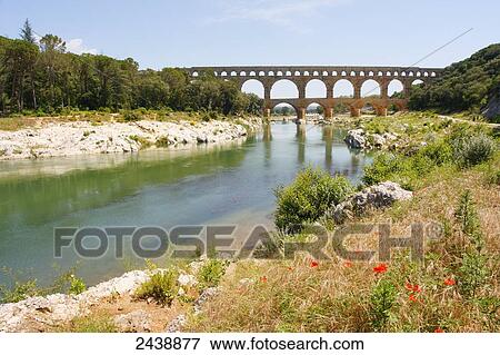 Stock Photo - Bridge across river, Pont Du Gard, Nimes, Languedoc Roussillon, France . Fotosearch