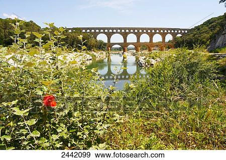 Bridge across river, Pont Du Gard, Nimes, Languedoc Roussillon, France View Large Photo Image Stock Photo - Bridge across river, Pont Du Gard, Nimes, Languedoc Roussillon, France . Fotosearch