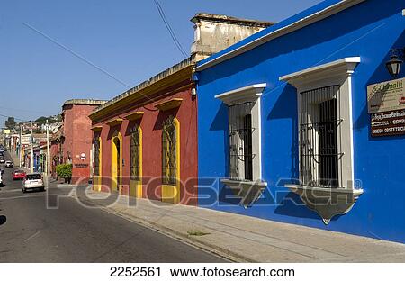 Cars on road along painted houses View Large Photo Image Stock Image - Cars on road along painted houses . Fotosearch