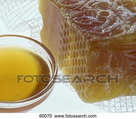 Stock Image - Close-up of honey in bowl . Fotosearch