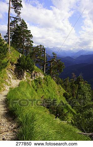 Stock Image - Clouds over mountain range, Bavaria, Germany . Fotosearch