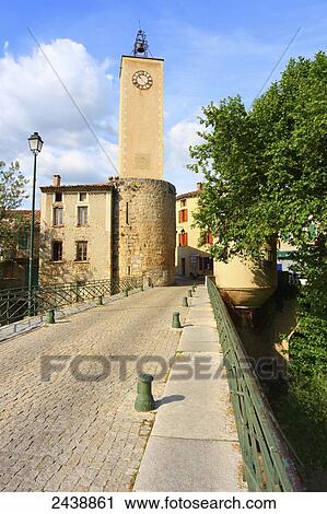 Stock Image - Cobblestone street leading to belltower, Mollans-Sur-Ouveze, Vaucluse, Provence-Alpes-Cote d'Azur, France . Fotosearch