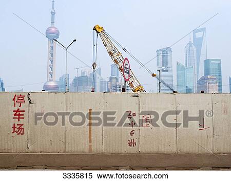 Crane behind a concrete wall, The Bund, Shanghai, China View Large Photo Image Stock Photography - Crane behind a concrete wall, The Bund, Shanghai, China . Fotosearch