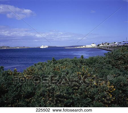 Stock Image - Cruise ship moored near coast of island, Falkland Islands, England . Fotosearch