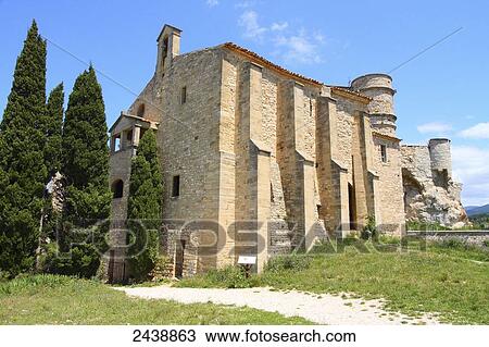 Stock Image - Cypress trees in front of church, Chapelle notre Dame La Brune, Vaucluse, Provence-Alpes-Cote d'Azur, France . Fotosearch