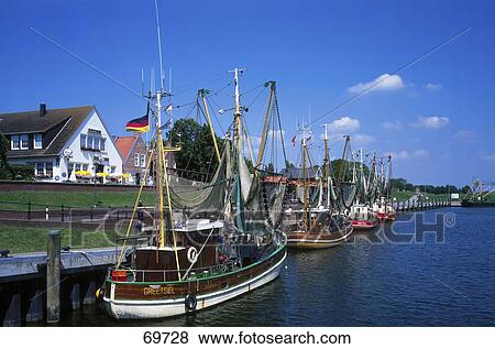 Europe Germany East Frisia Greesiel port houses pier fishing boats canal river View Large Photo Image Stock Photo - Europe Germany East Frisia Greesiel port houses pier fishing boats canal river . Fotosearch