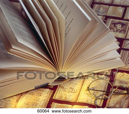 Picture - High angle view of book and eyeglasses . Fotosearch