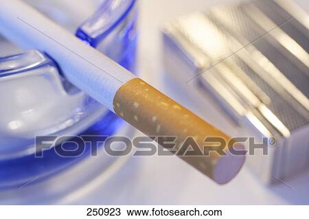 High angle view of cigarette on ashtray View Large Photo Image Stock Image - High angle view of cigarette on ashtray . Fotosearch
