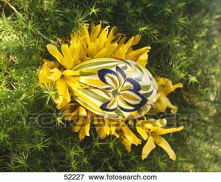 Stock Photo - High angle view of Easter egg and flowers . Fotosearch