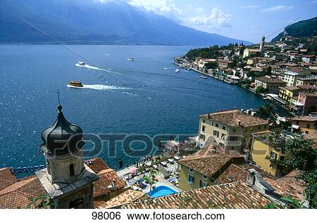 Stock Photograph - High angle view of town on the coast, Lake Garda, Italy . Fotosearch
