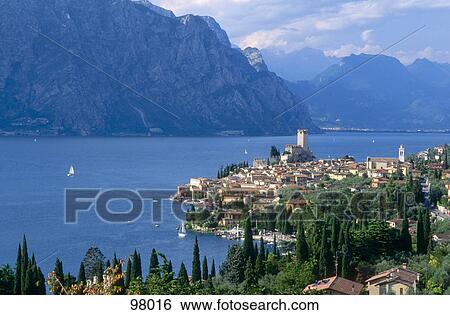High angle view of village at lakefront, Lake Garda, Malcesine, Veneto, Italy View Large Photo Image Stock Photograph - High angle view of village at lakefront, Lake Garda, Malcesine, Veneto, Italy . Fotosearch