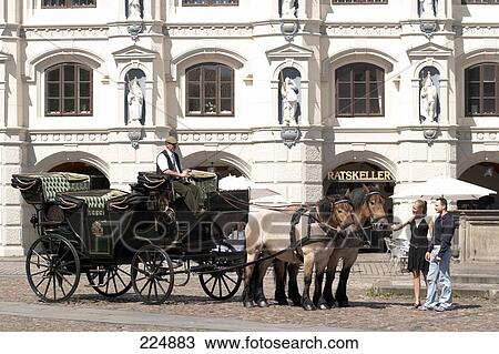 Horse coach in front of city hall, Lueneburg, Germany View Large Photo Image Stock Image - Horse coach in front of city hall, Lueneburg, Germany . Fotosearch