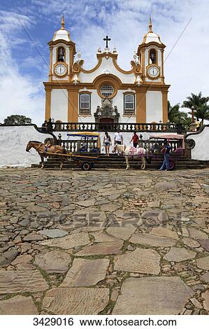 Stock Photograph - Horsedrawn carriages in front of Santo Antonio Church, Tiradentes, Minas Gerais, Brazil . Fotosearch