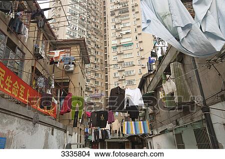 Laundry drying in a working class area, Shanghai, China, low angle view View Large Photo Image Picture - Laundry drying in a working class area, Shanghai, China, low angle view . Fotosearch