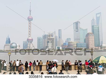 People at the waterfront of the Huangpu River, Shanghai, China View Large Photo Image Stock Photograph - People at the waterfront of the Huangpu River, Shanghai, China . Fotosearch