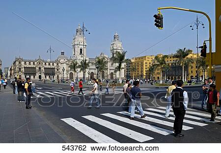 Stock Image - People walking on zebra crossing, Plaza-De-Armas, Lima, Lima Province, Lima Region, Peru . Fotosearch