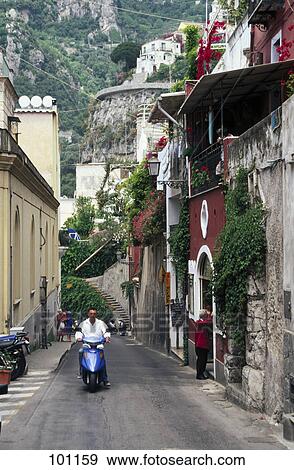 Stock Photo - Person on motor scooter in street, Positano, Amalfi, Italy . Fotosearch