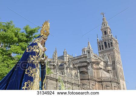 Procession with cathedral and Giralda tower in the back, Sevilla, Andalucia, Spain View Large Photo Image Picture - Procession with cathedral and Giralda tower in the back, Sevilla, Andalucia, Spain . Fotosearch