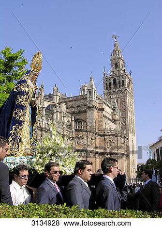 Procession with cathedral and Giralda tower in the back, Sevilla, Andalucia, Spain View Large Photo Image Stock Photo - Procession with cathedral and Giralda tower in the back, Sevilla, Andalucia, Spain . Fotosearch