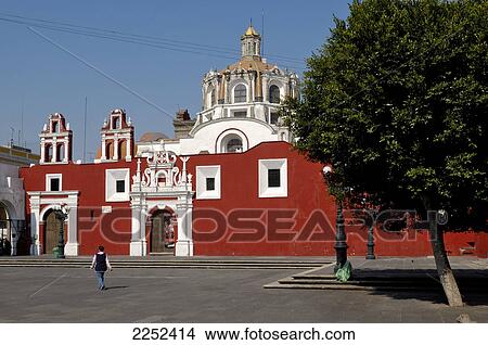 Picture - Rear view of woman walking in front of church . Fotosearch