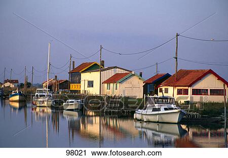 Reflection of boats and houses in water, La Tremblade, Charentes-Maritime, France View Large Photo Image Stock Image - Reflection of boats and houses in water, La Tremblade, Charentes-Maritime, France . Fotosearch