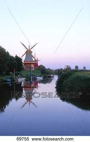 Stock Photography - Reflection of windmill in water, Greetsiel, East Ffrisia, Lower Saxony, Germany . Fotosearch