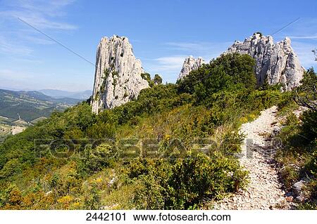 Stock Image - Rock formations on landscape, Dentelles de Montmirail, Vaucluse, Provence-Alpes-Cote d'Azur, France . Fotosearch