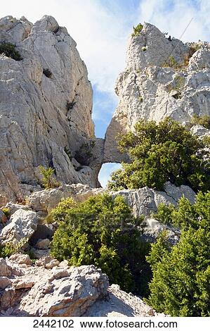 Stock Image - Rock formations on landscape, Dentelles de Montmirail, Vaucluse, Provence-Alpes-Cote d'Azur, France . Fotosearch