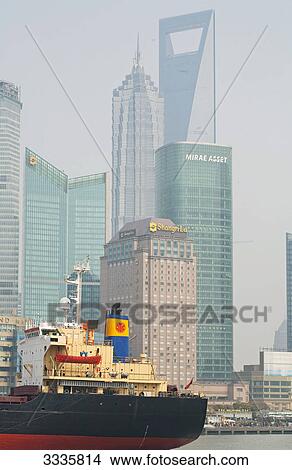 Ship on a river, Skyscrapers in the background, Shanghai, China View Large Photo Image Picture - Ship on a river, Skyscrapers in the background, Shanghai, China . Fotosearch