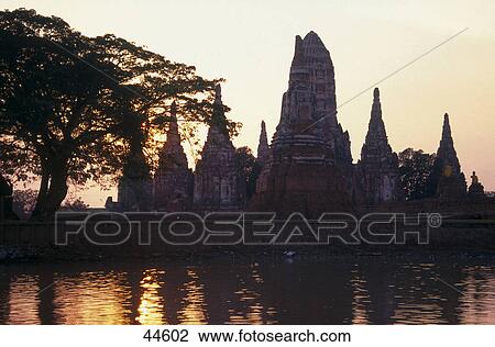 Stock Image - Silhouette of stupas at waterfront, Wat Chai Wattanaram, Ayutthaya, Thailand . Fotosearch