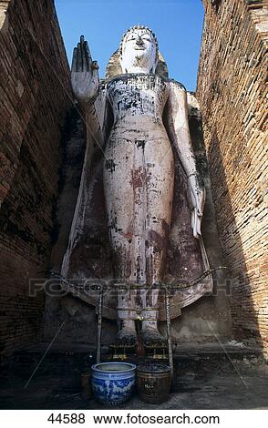 Stock Photo - Standing Buddha statue, Wat Mahathat, Sukhothai, Thailand . Fotosearch
