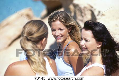 Three young women sitting on beach View Large Photo Image Stock Photography - Three young women sitting on beach . Fotosearch