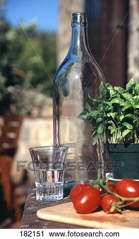 Tomatoes with glass and bottle of water View Large Photo Image Stock Image - Tomatoes with glass and bottle of water . Fotosearch