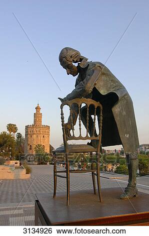 Stock Photograph - Torre del oro and sculpture, Sevilla, Andalucia, Spain . Fotosearch