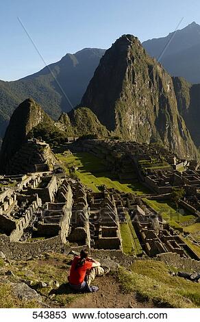 Tourist looking at old ruins on mountain, Inca Ruins, Machu Picchu, Cusco Region, Peru View Large Photo Image Stock Image - Tourist looking at old ruins on mountain, Inca Ruins, Machu Picchu, Cusco Region, Peru . Fotosearch