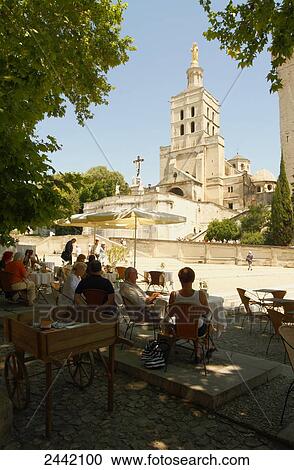 Stock Image - Tourists at pavement cafe, Avignon, Vaucluse, Provence-Alpes-Cote d'Azur, France . Fotosearch