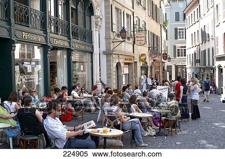 Tourists at sidewalk cafe in town, Lausanne, Switzerland View Large Photo Image Stock Photography - Tourists at sidewalk cafe in town, Lausanne, Switzerland . Fotosearch
