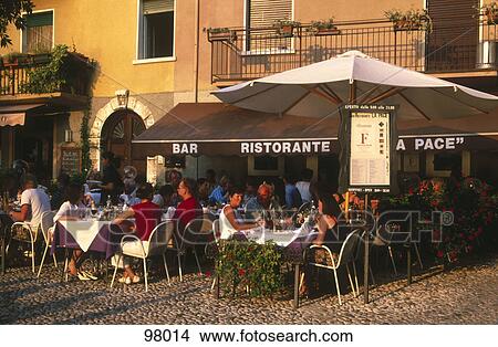 Tourists at sidewalk cafe, Italy View Large Photo Image Picture - Tourists at sidewalk cafe, Italy . Fotosearch