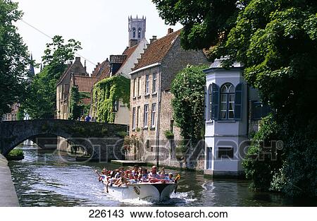 Tourists in a tour boat in a canal View Large Photo Image Stock Image - Tourists in a tour boat in a canal . Fotosearch