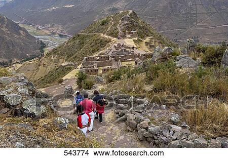 Tourists looking at old ruins, Inca Ruins, Machu Picchu, Cusco Region, Peru View Large Photo Image Picture - Tourists looking at old ruins, Inca Ruins, Machu Picchu, Cusco Region, Peru . Fotosearch