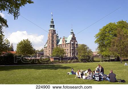 Tourists resting in park with castle in background, Rosenborg Castle, Copenhagen, Denmark View Large Photo Image Stock Image - Tourists resting in park with castle in background, Rosenborg Castle, Copenhagen, Denmark . Fotosearch