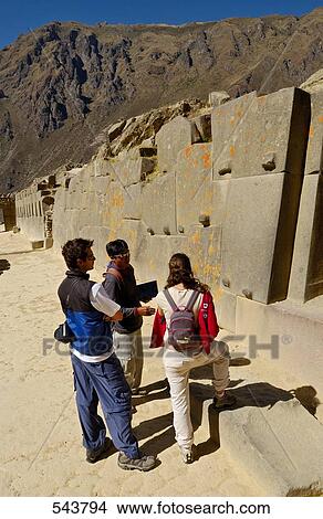 Picture - Tourists watching old ruins, Ollantaytambo, Urubamba Province, Cusco Region, Peru . Fotosearch