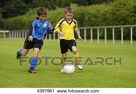 Two boys playing football View Large Photo Image Stock Image - Two boys playing football . Fotosearch