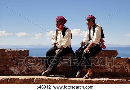 Two men sitting on ledge at lakeside, Lake Titicaca, Peru View Large Photo Image Stock Image - Two men sitting on ledge at lakeside, Lake Titicaca, Peru . Fotosearch